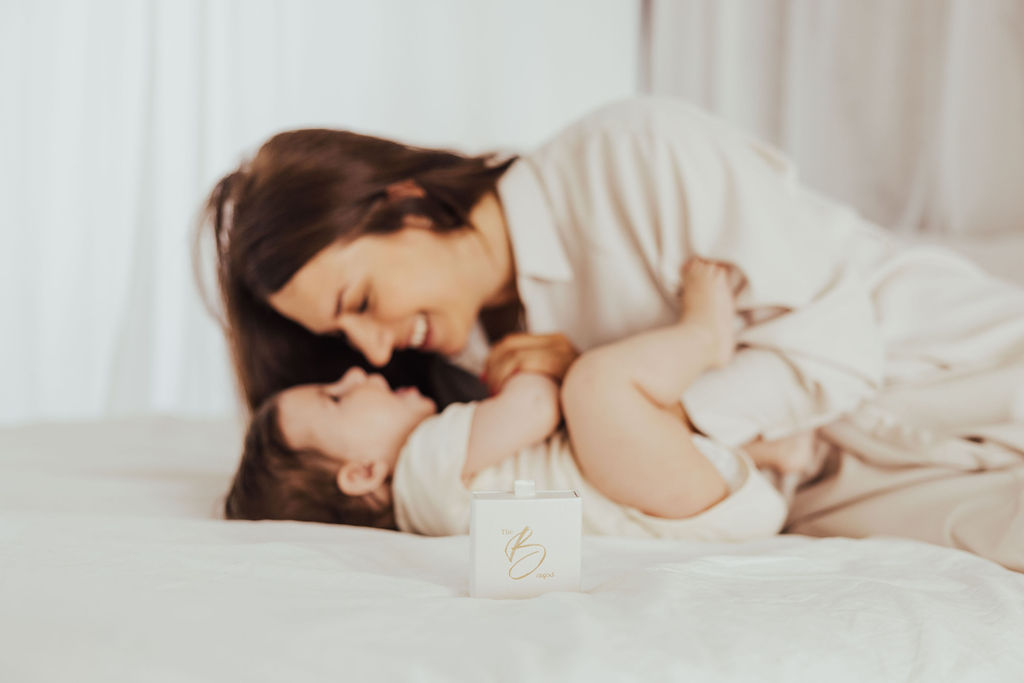 Mother gently holding her sleeping baby